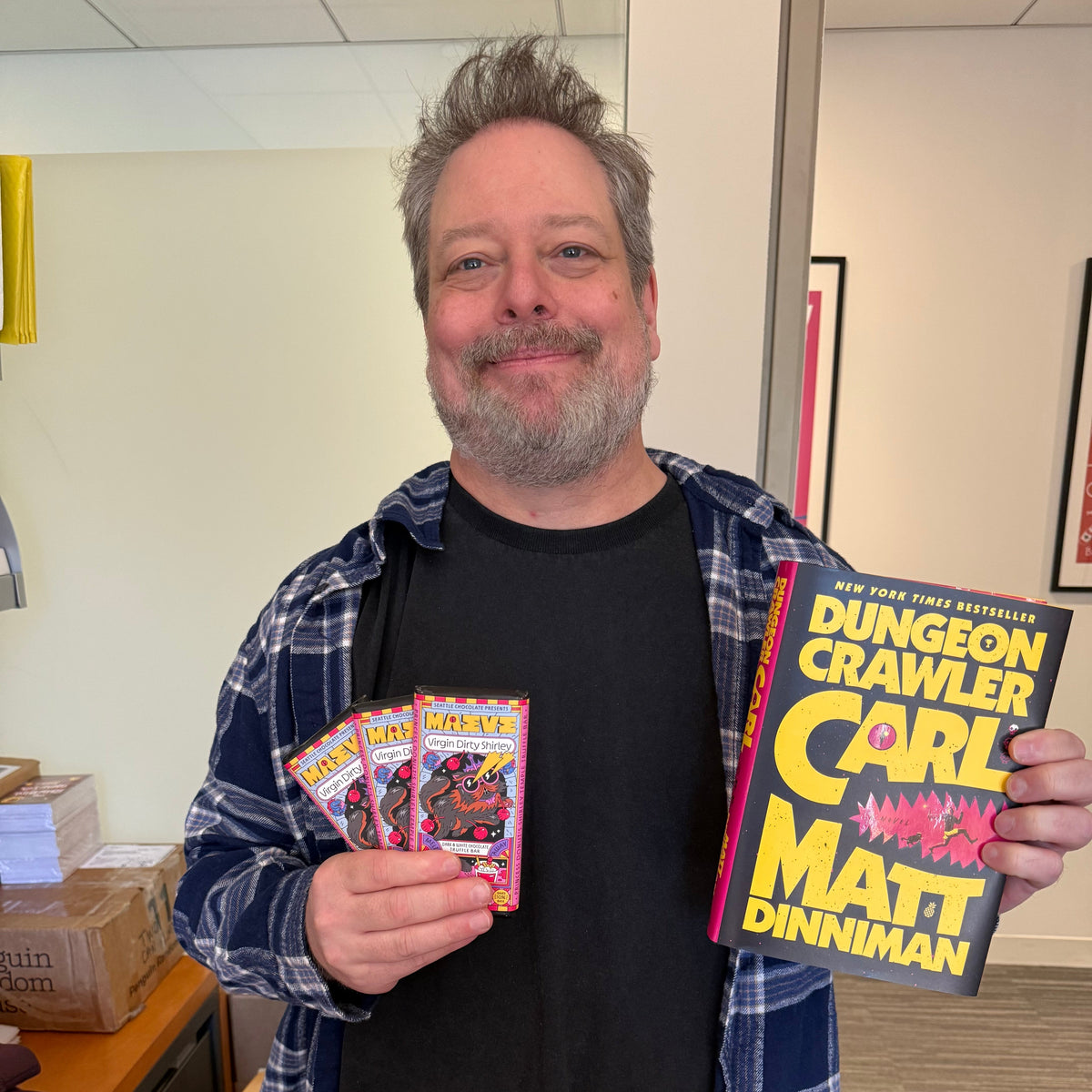 Photo of Matt Dinniman, author of Dungeon Crawler Carl, with Maeve Chocolate Virgin Dirty Shirley Chocolate Bar